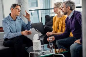 male-therapist-talking-couple-during-marriage-counseling-office_637285-11124