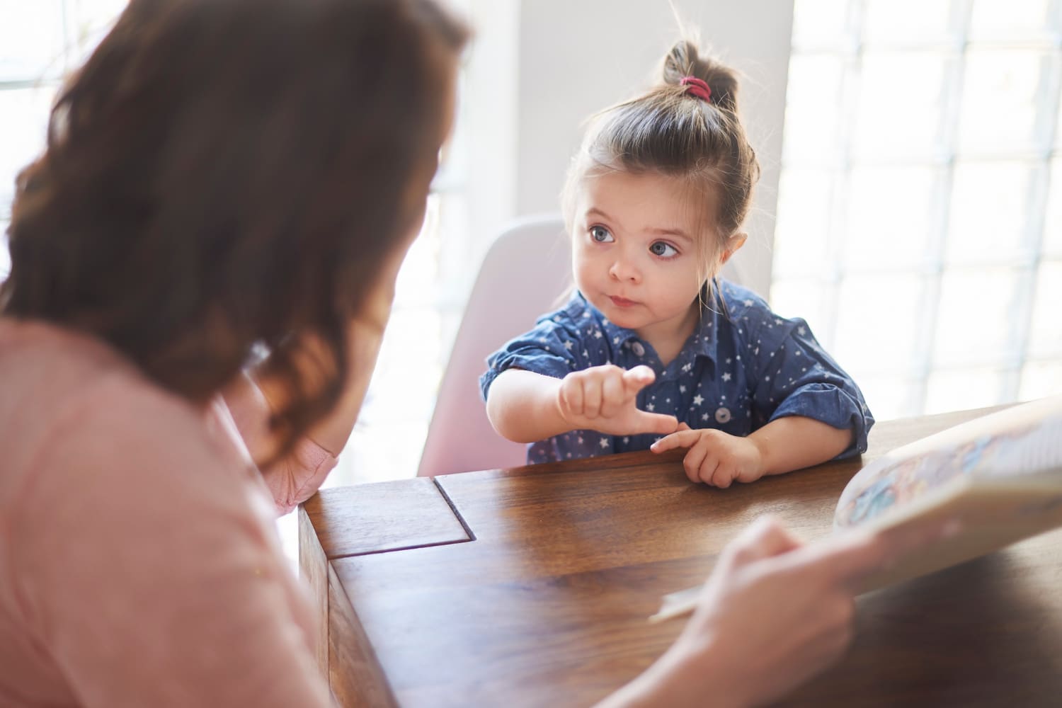 cute-girl-with-mom-reading-book